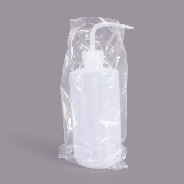 Transparent plastic ink bottle cover sealed in clear packaging on gray background